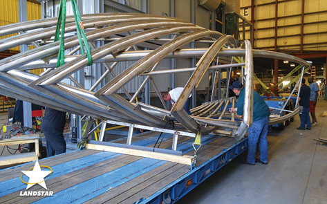 Over-dimensional sculpture loaded on an extendable trailer.
