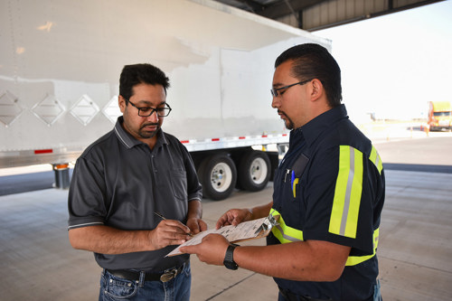 Freight agent and owner-operator collaborating on safety plan.
