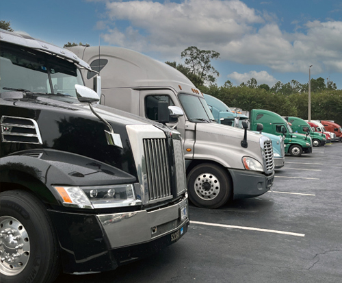 Landstar owner-operators' trucks parked in a parking lot