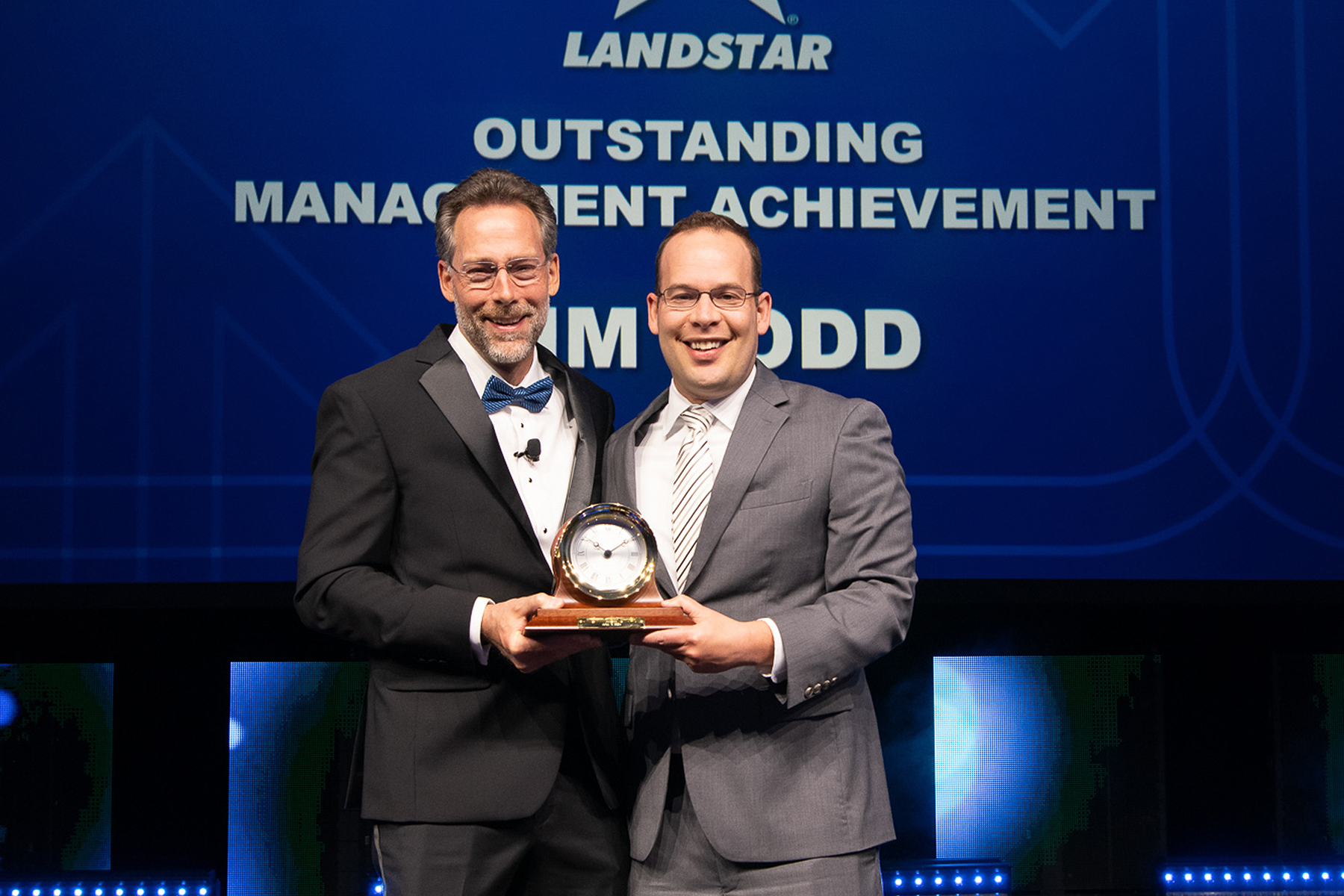 Landstar President and CEO Frank Lonegro (left) presents Chief Financial Officer Jim Todd (right) with the Landstar Outstanding Management Achievement Award