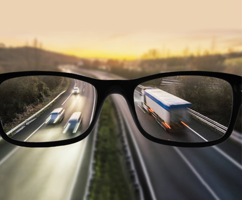 Image of glasses in front of a road